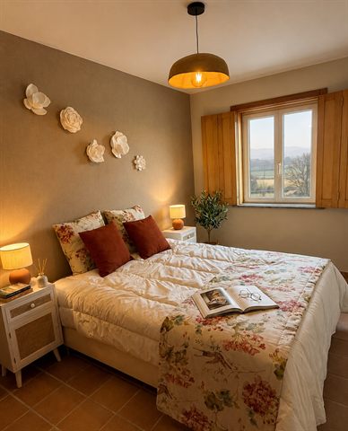 The main bedroom, with a queen-size bed and a window looking out over open countryside