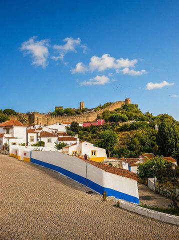 Óbidos castle and the town walls on the hill above the street